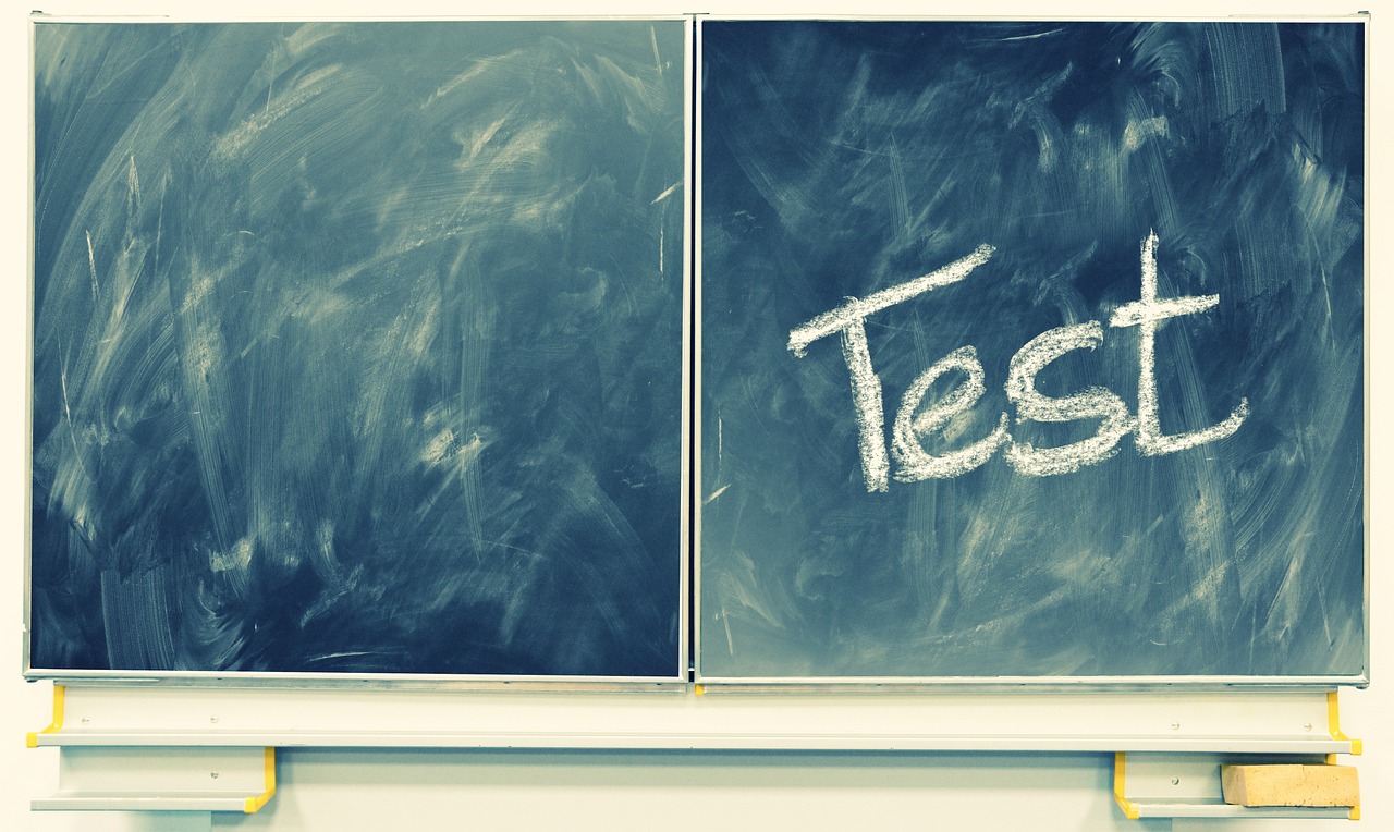 Chalkboard with the word “Test” written on it, symbolizing the importance of load testing and performance checks during speed optimization for Shopify stores before peak traffic events.