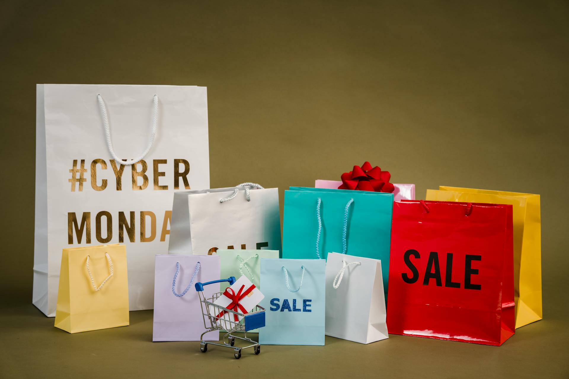 Colorful shopping bags with Cyber Monday and sale signs, symbolizing high-traffic events where speed optimization for Shopify is critical for maximizing conversions and performance.