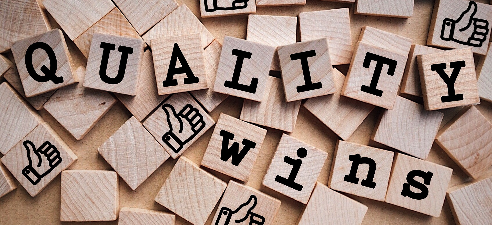 Wooden letter tiles spelling “Quality Wins” with thumbs-up icons, symbolizing choosing trusted Shopify apps, customer reviews, and reliable eCommerce store performance.