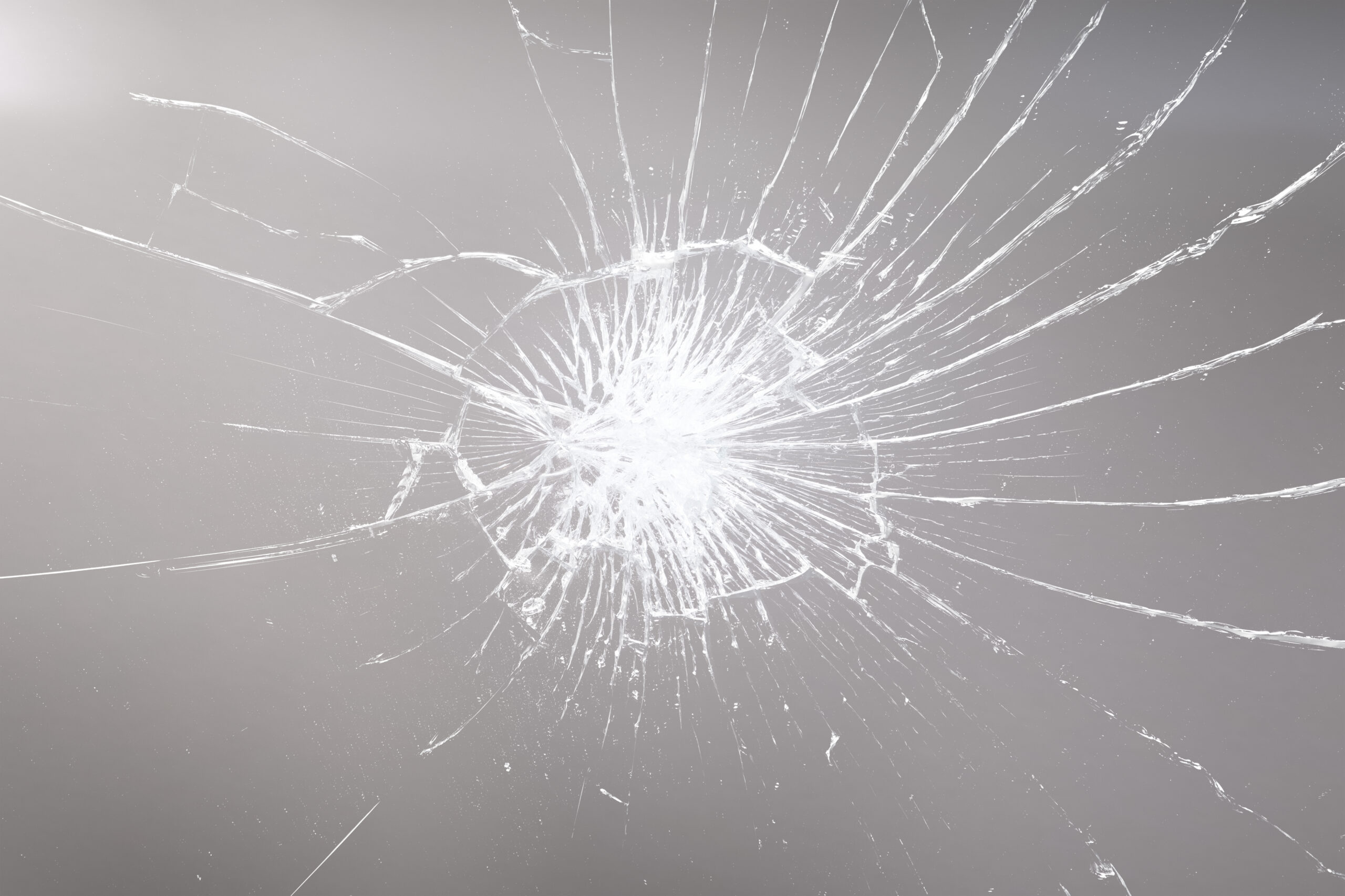 Close-up of a cracked and shattered glass surface, symbolizing broken Shopify themes, app conflicts, and ecommerce store errors.