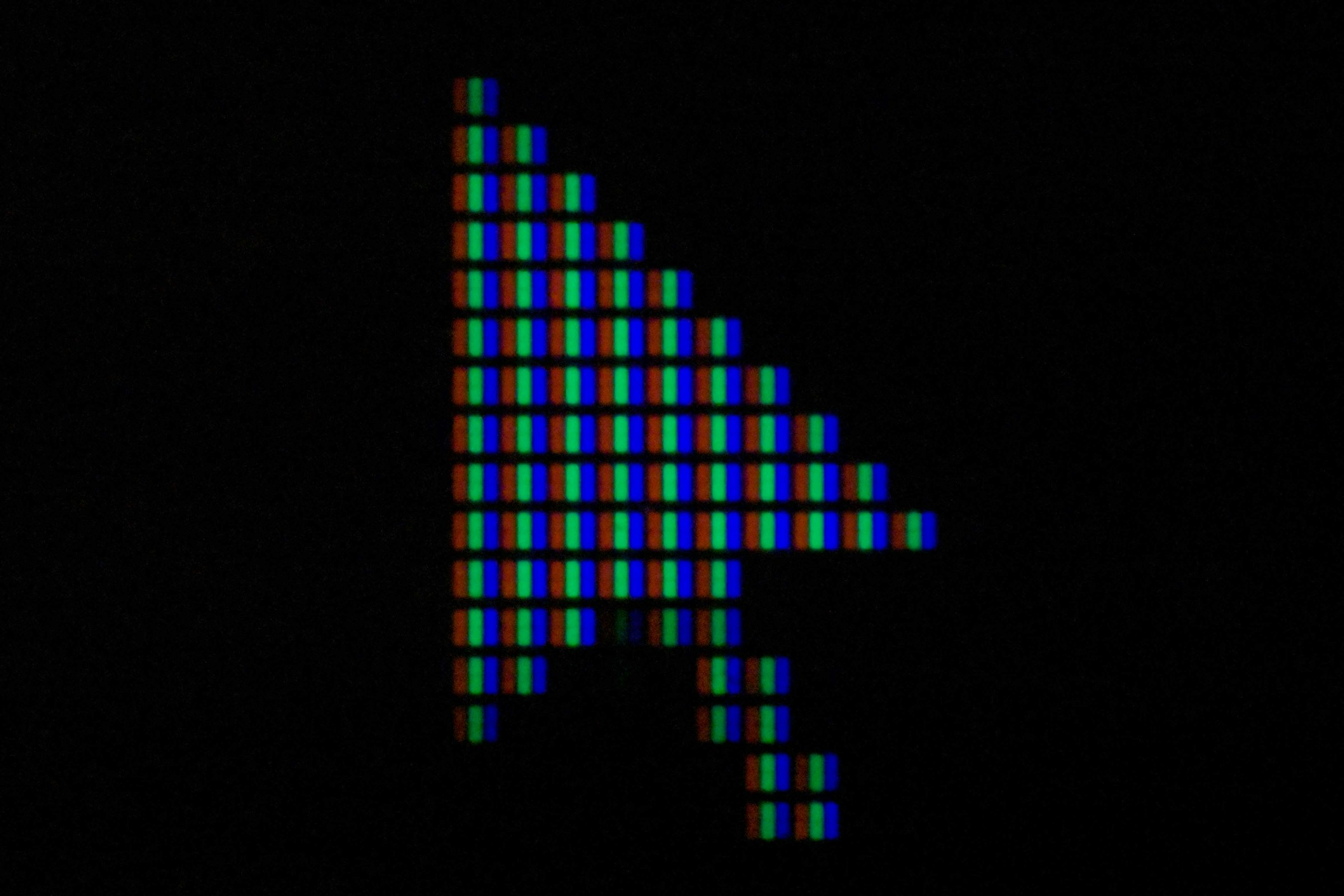 Tracking Pixels That Convert: How to Use Them Effectively 14 Close-up digital cursor arrow made of RGB pixels on a dark screen, symbolizing tracking pixels and online user behavior monitoring.