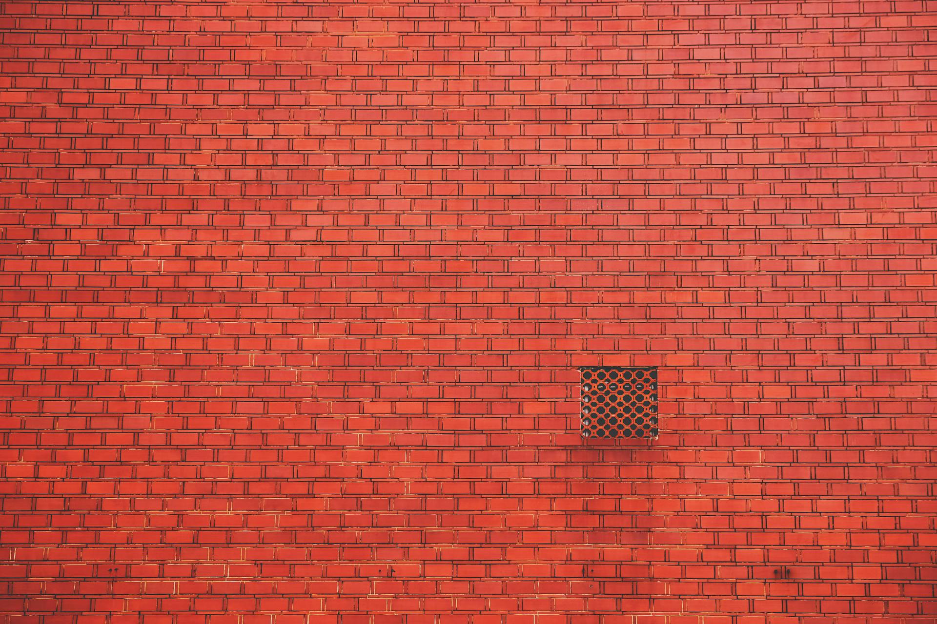 Tracking Pixels That Convert: How to Use Them Effectively 10 ed brick wall with a small square ventilation grate, minimalist architecture background.