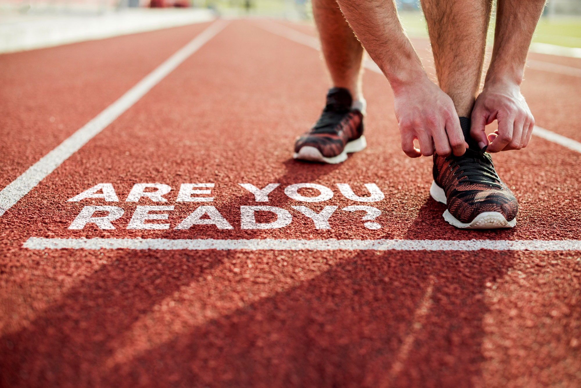 Understanding the Accessibility Act: A Shopify Merchant’s Guide to EAA 2025 14 Athlete tying shoelaces on a running track next to the words “ARE YOU READY?” symbolizing preparation for EAA 2025 compliance and upcoming Accessibility Act deadlines for ecommerce businesses.