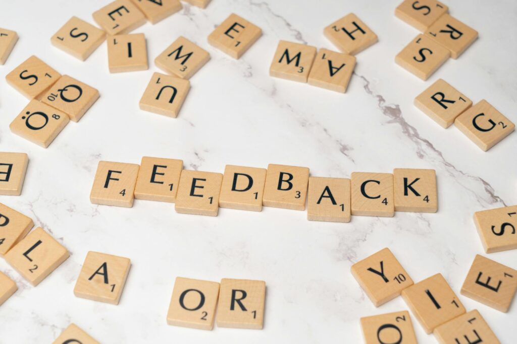 Scrabble tiles spelling the word “FEEDBACK” on a marble surface, symbolizing customer reviews and user feedback in ecommerce.