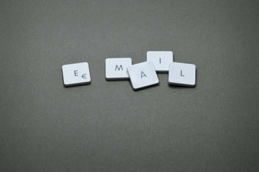 White keyboard keys spelling “EMAIL” on a gray background, representing digital communication and email marketing.