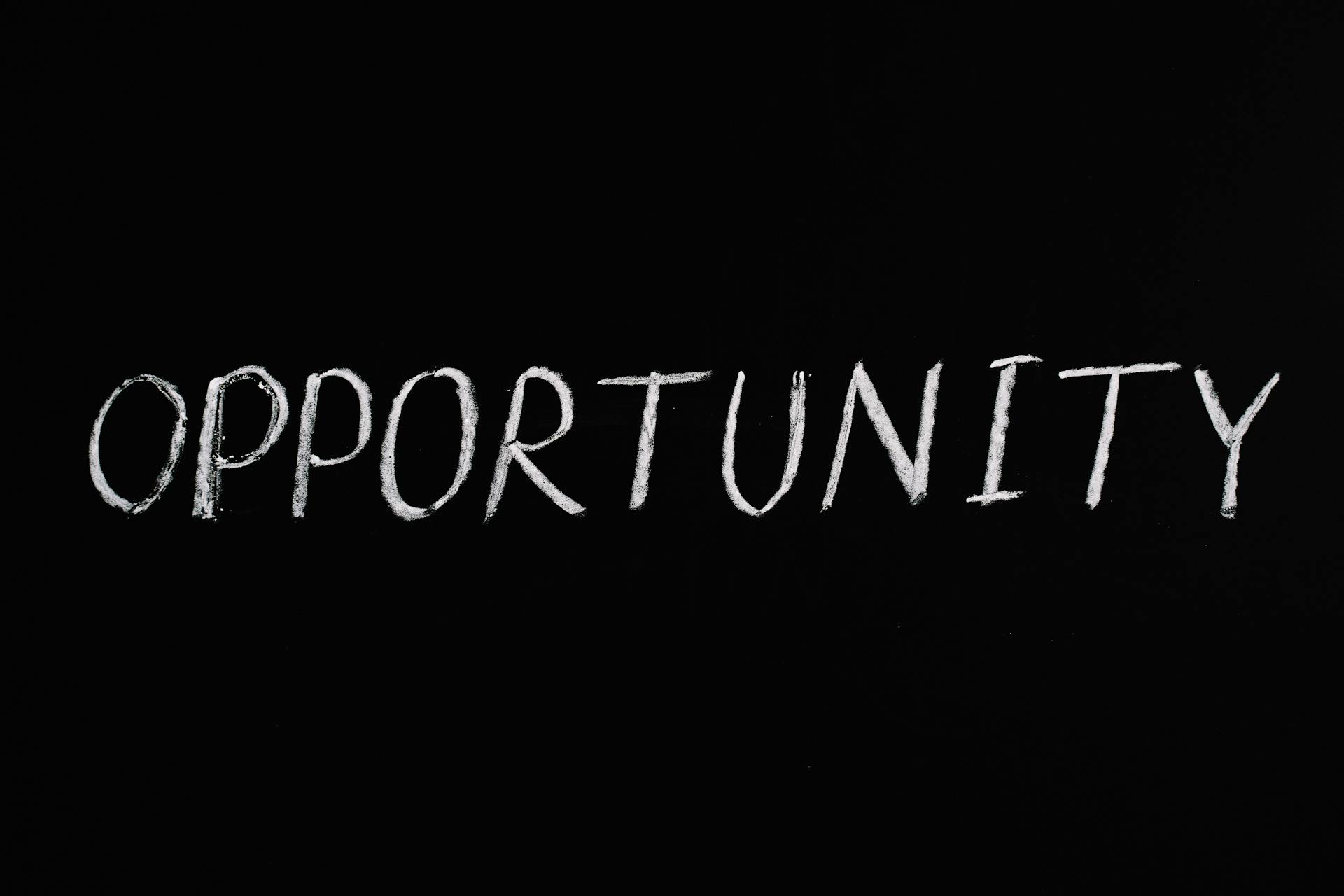 Understanding the Accessibility Act: A Shopify Merchant’s Guide to EAA 2025 16 The word “Opportunity” handwritten in white chalk on a black background, representing how the EAA 2025 turns Accessibility Act compliance into a growth opportunity for Shopify merchants.