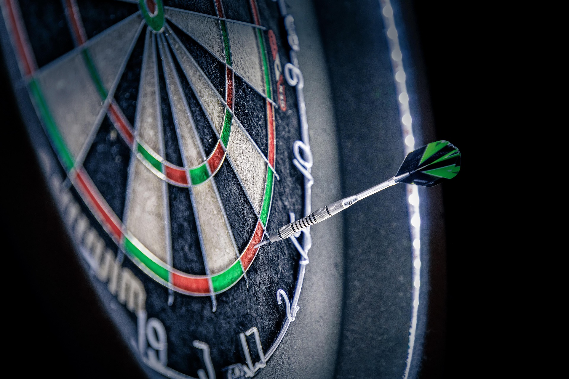 Close-up of a dart hitting the edge of a dartboard, symbolizing near-miss targeting in paid ads, PPC campaigns, and digital marketing strategies