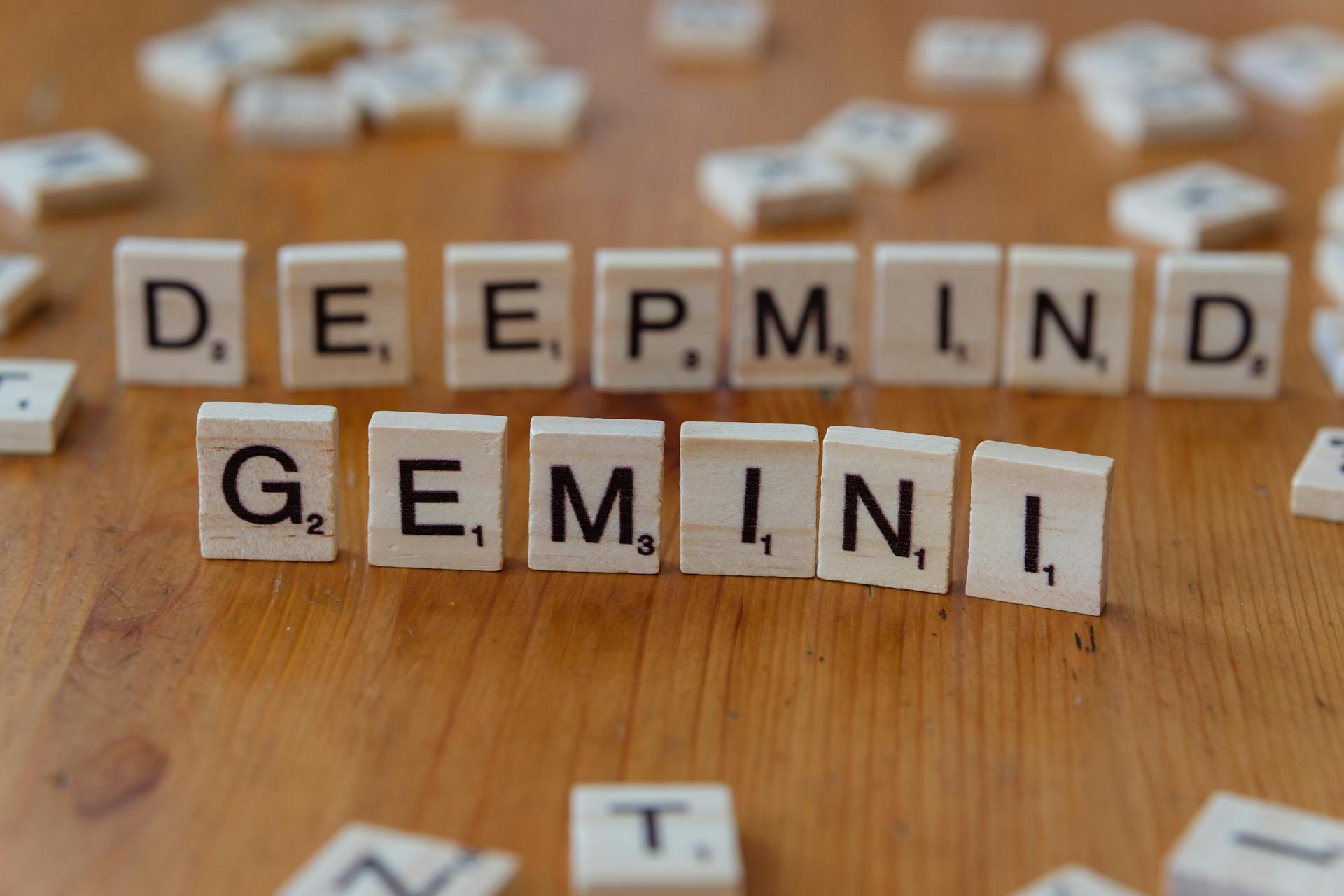 Scrabble tiles spelling out “DeepMind Gemini,” symbolizing the impact of advanced AI models like Gemini on the future of AI in commerce.