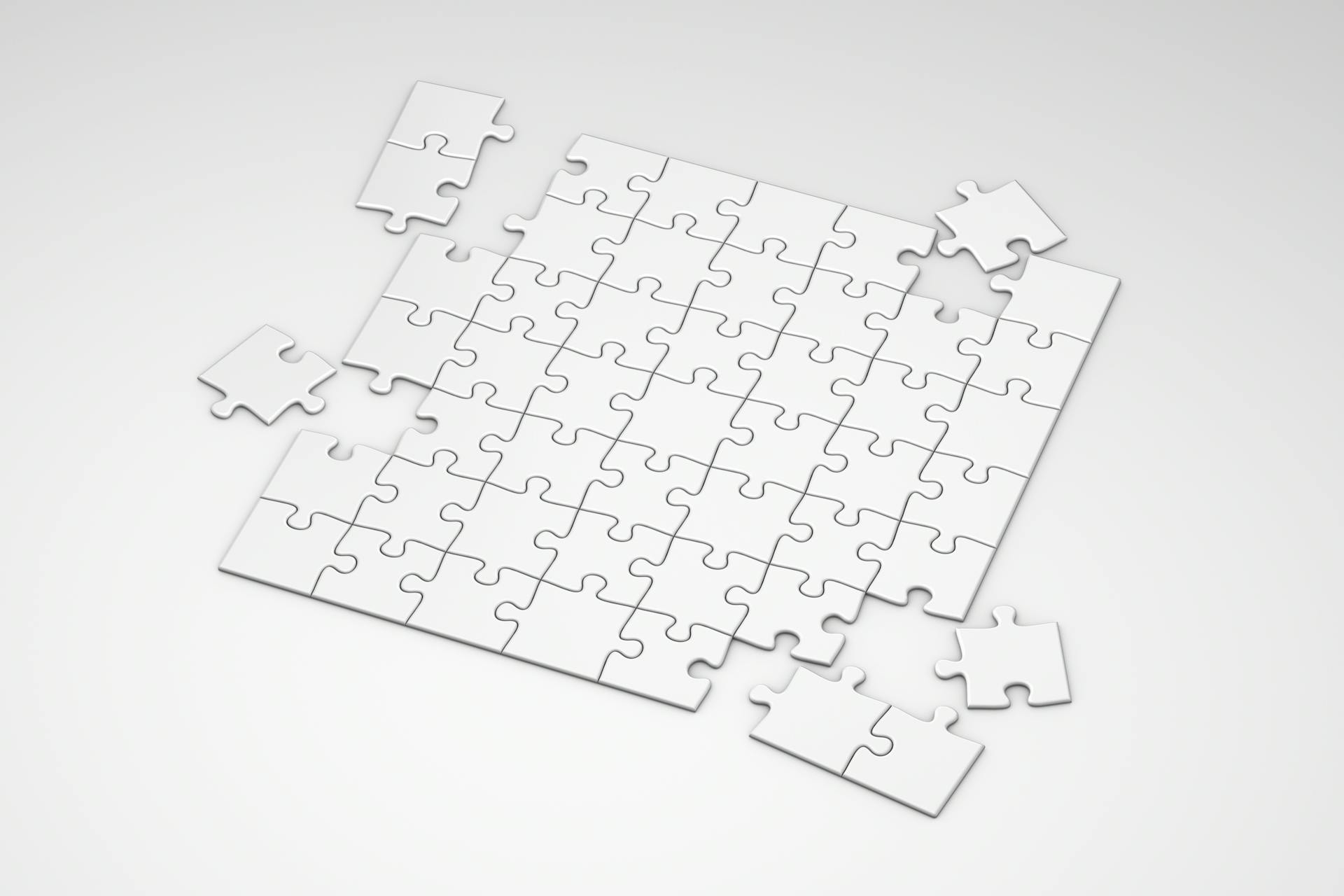 White jigsaw puzzle with a few missing pieces, symbolizing the evolving landscape of digital search and the relationship between AEO vs GEO.