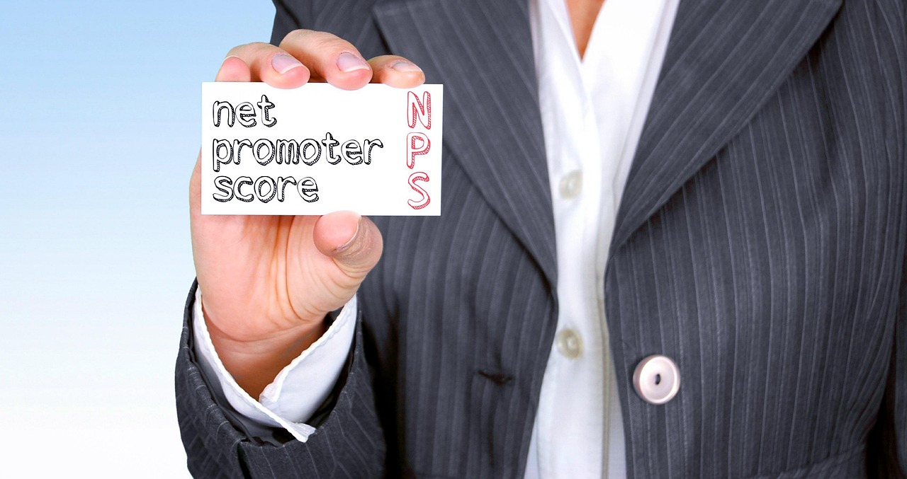Business person holding a card labeled ‘Net Promoter Score (NPS)’, highlighting customer satisfaction metrics used in Ecommerce Conversion Optimization to improve loyalty and boost conversions.