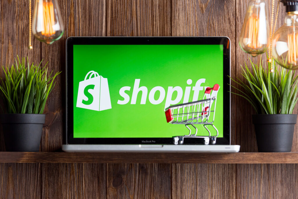 Shopify store on a laptop screen with shopping cart symbol, representing Ecommerce Conversion Optimization strategies for online retail success.