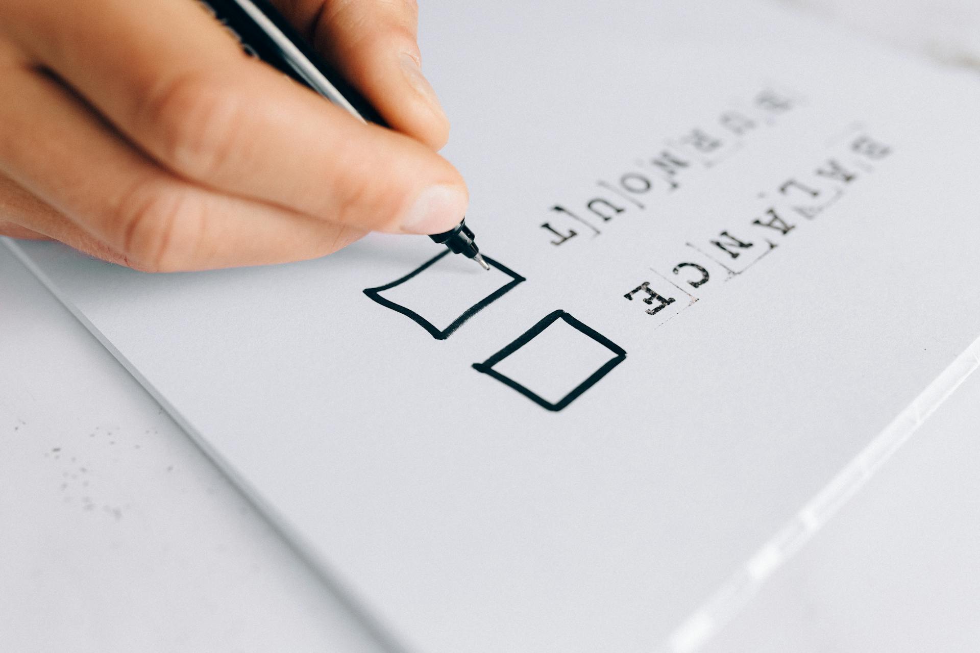 Hand marking checklist representing ecommerce bounce rate tracking limitations, where analytics tools fail to capture early exits caused by slow page load speed and invisible user behavior