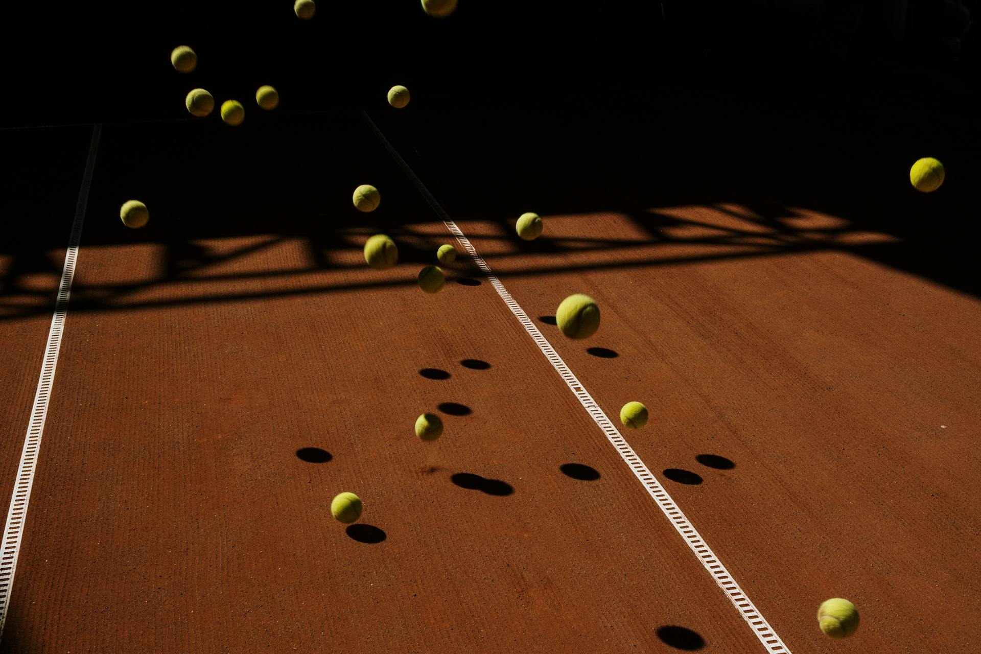Multiple tennis balls bouncing on court representing ecommerce bounce rate, where users leave instantly and must be retained through faster page load speed and better user experience