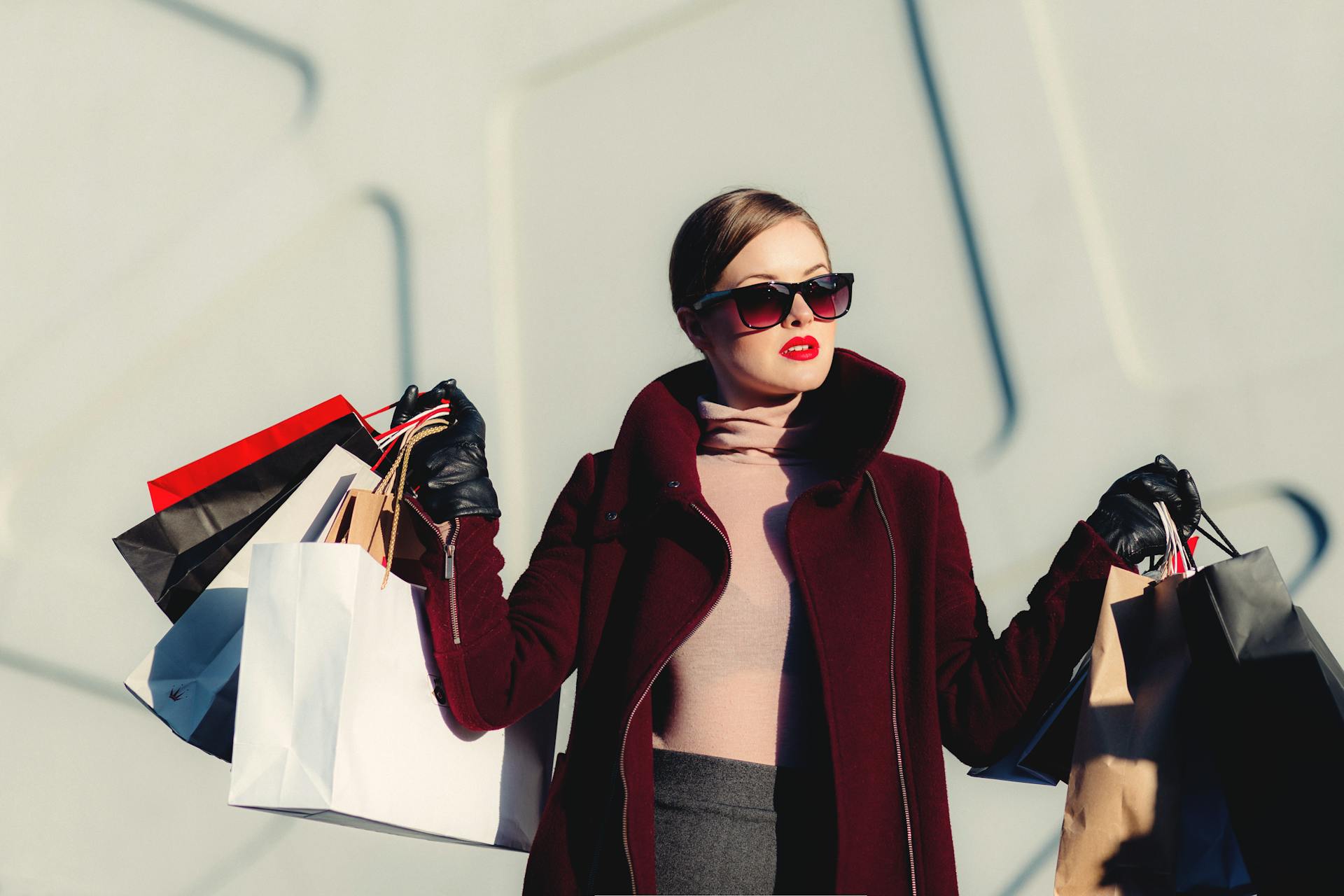Fashion shopper holding multiple shopping bags, representing online shopping and product discovery powered by AI shopping and optimized product detail pages (PDPs).