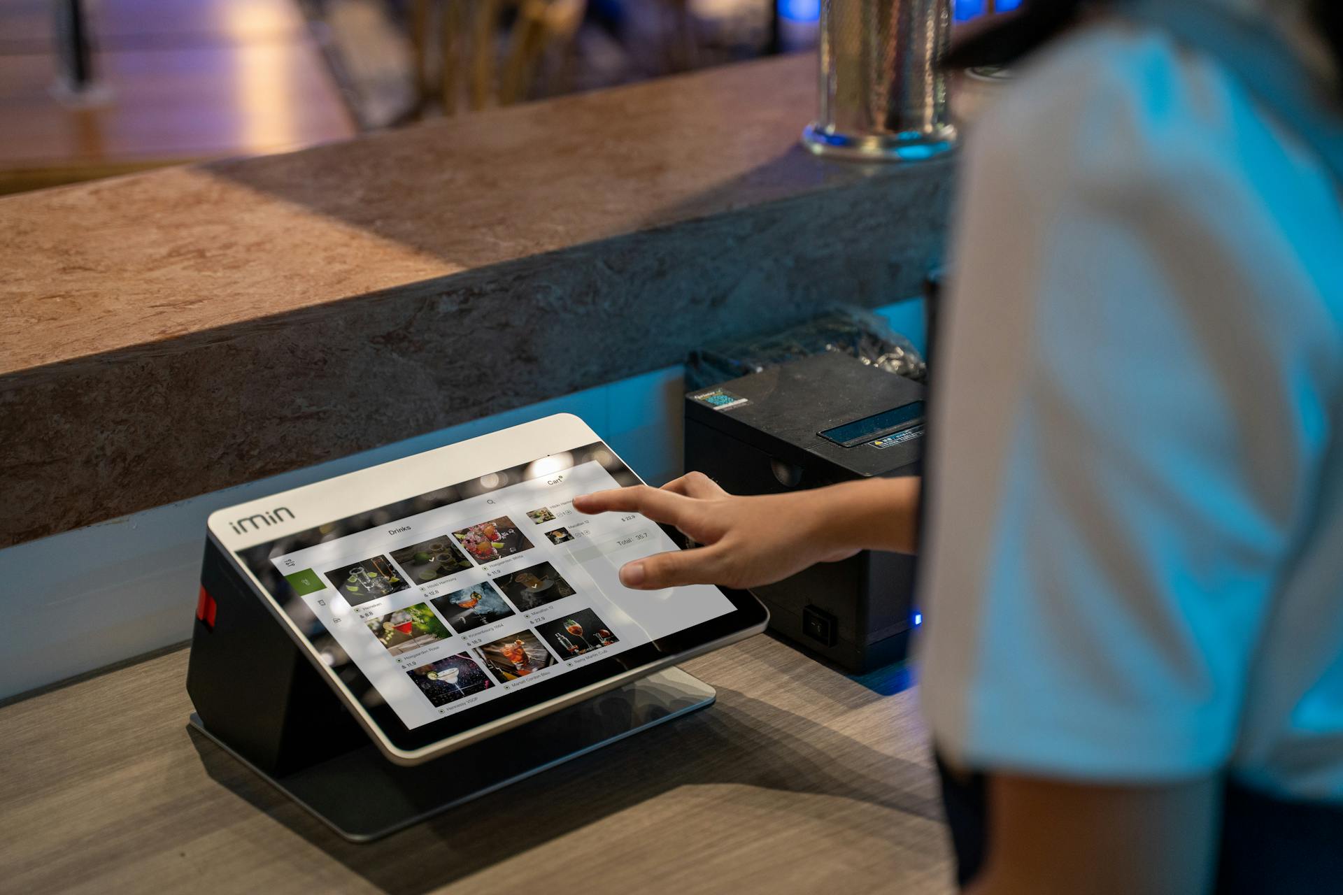 Point-of-sale tablet in use at checkout, representing Shopify revenue generation through transactions and payment processing