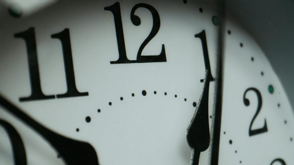 Close-up of a clock showing time passing, representing how a 1-second delay impacts Shopify revenue and ecommerce performance