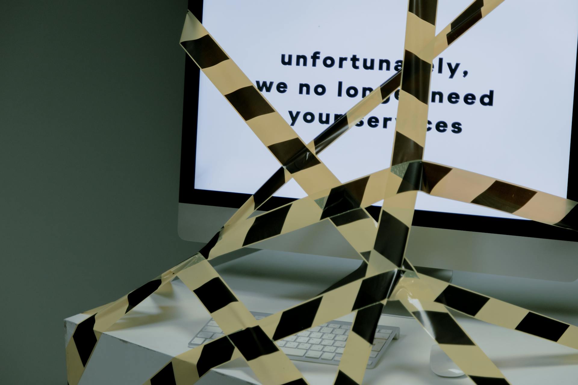 Computer screen blocked by warning tape, illustrating how render-blocking resources interrupt the critical rendering path, delay visible content, and slow Shopify page performance.