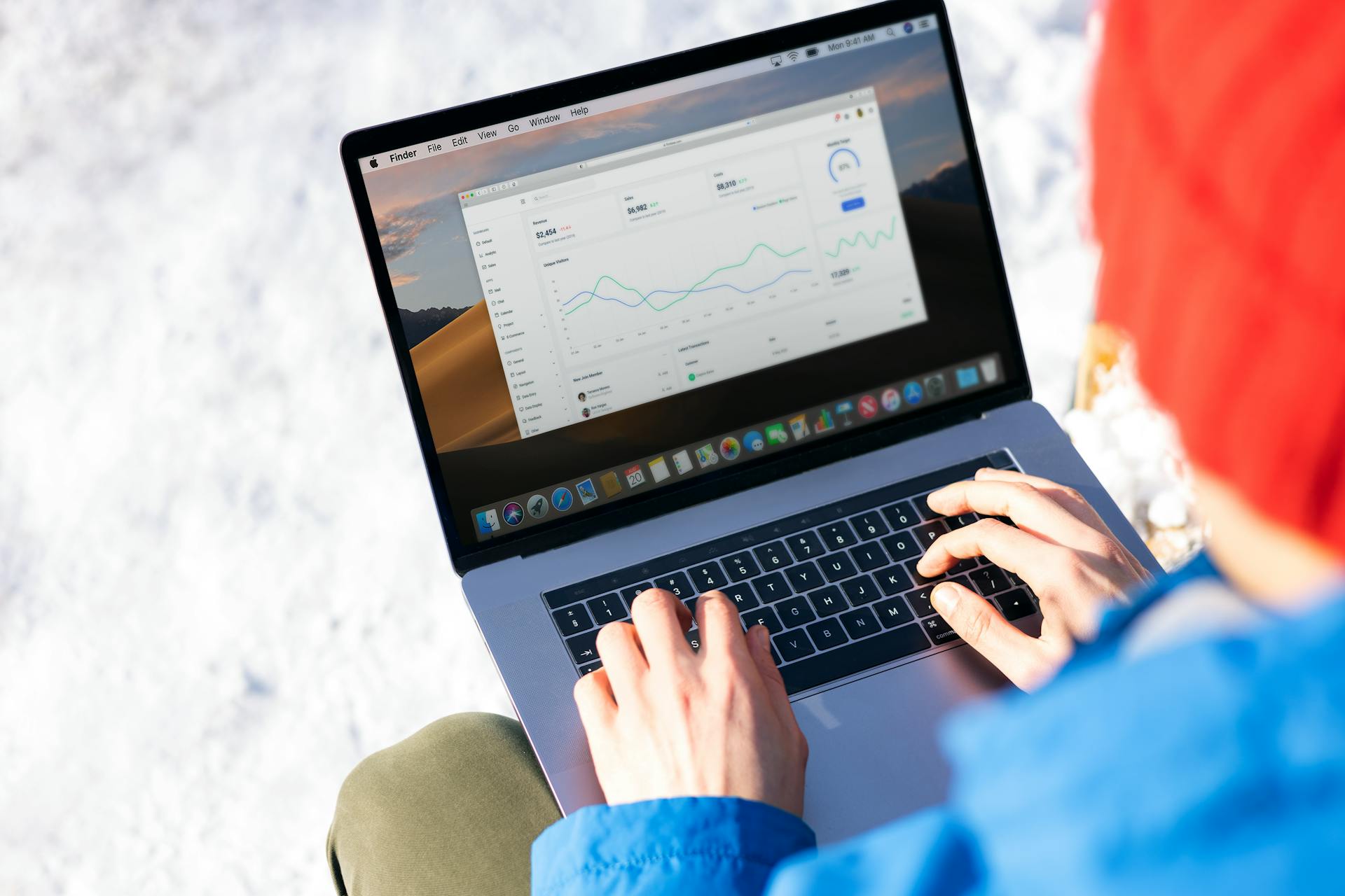 Person reviewing website performance metrics on a laptop, representing the use of PageSpeed Insights, Lighthouse, Chrome DevTools, and performance audits to verify render-blocking resource optimizations and Shopify speed improvements.