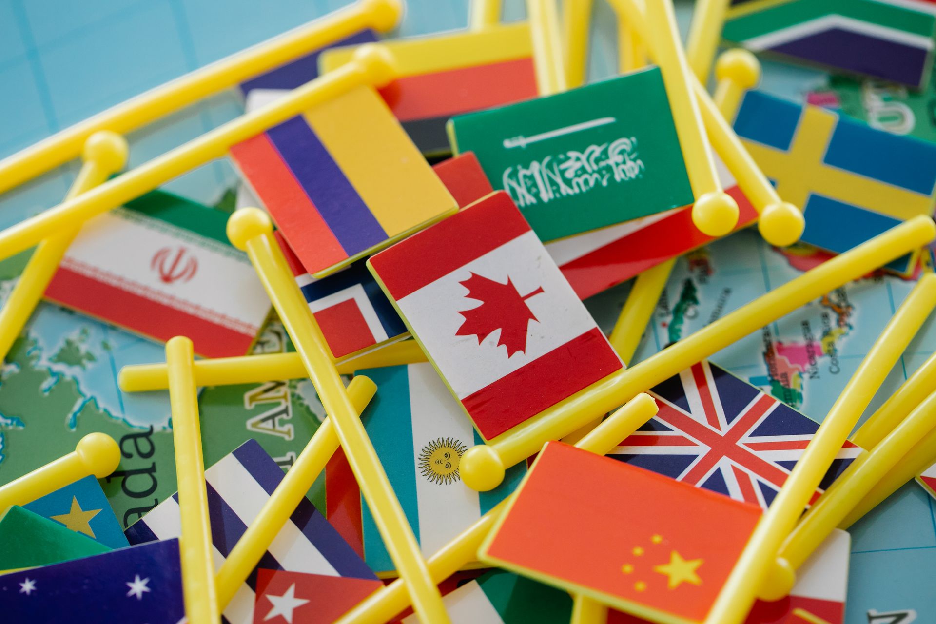 What is a CDN: World map with country flags representing a global content delivery network that serves website visitors from locations worldwide