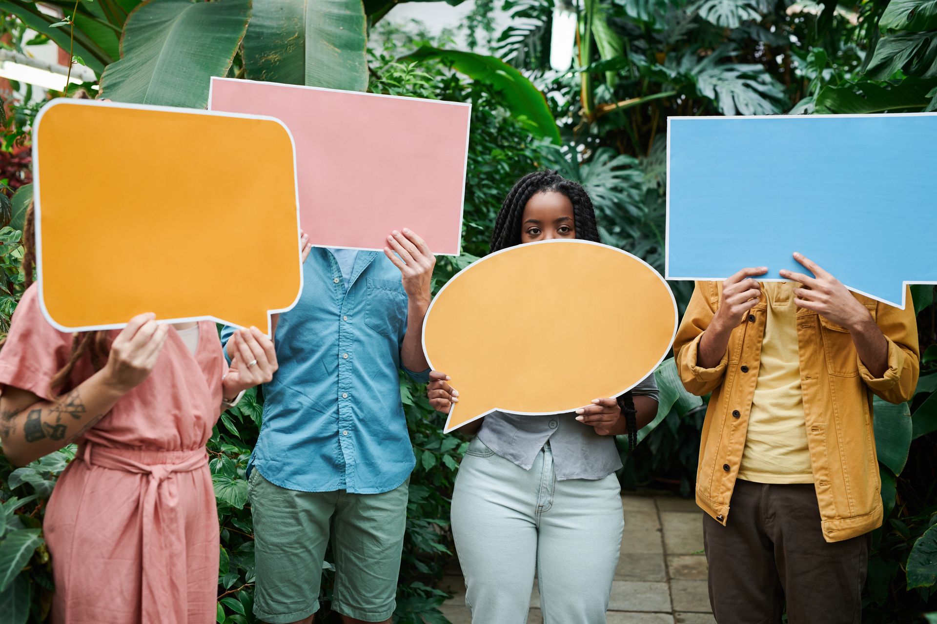 People holding speech bubbles representing customer feedback for a Shopify Product Reviews App and social proof