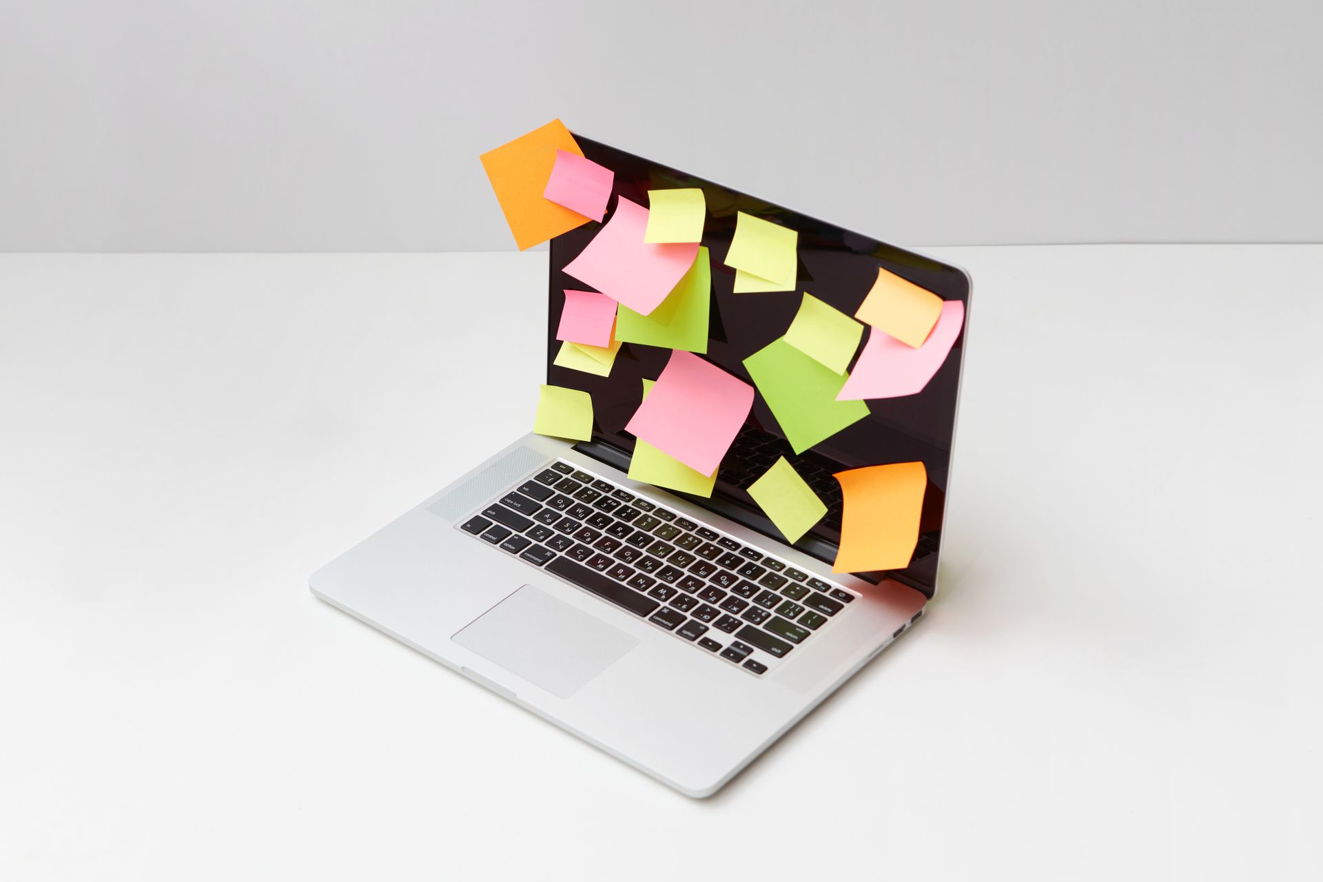 Laptop with multiple sticky notes illustrating popup overload that hurts user experience and ecommerce conversion rates.