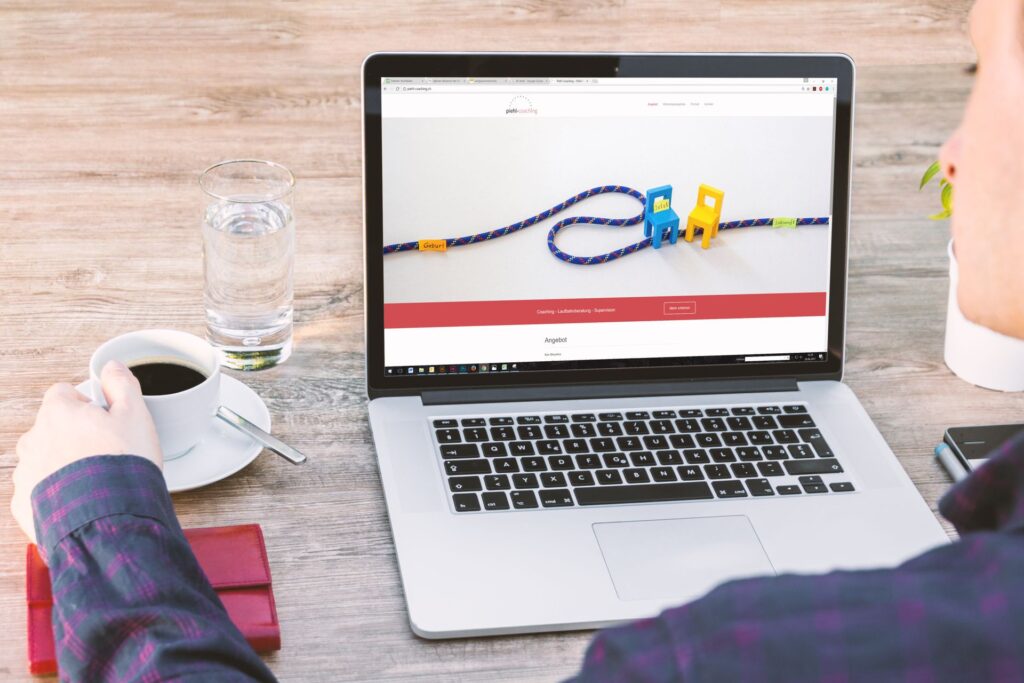 Person viewing a website on a laptop, illustrating how a Shopify page builder can affect store design, speed, and performance.